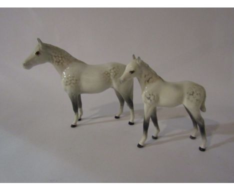 A Beswick Thoroughbred Stallion (small) in grey gloss, model no. 1992 together with a Beswick Foal (large Thoroughbred type) 