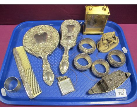 A Plated Three Piece Dressing Table Set, a set of four decorative napkin rings, a vintage engine turned lighter, Avia clock, 