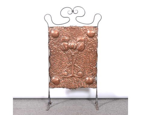 Arts and Crafts copper firescreen with wrought iron strapwork frame, the copper panel embossed with a cluster of stylised pom