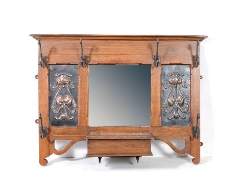 English Arts and Crafts, oak hallway coat/hat stand, with an arrangement of six hooks surrounding two repousse panels with st