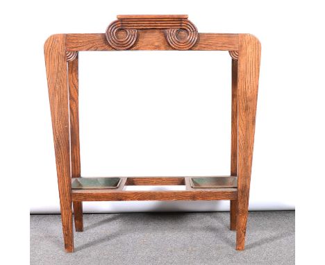 An Art Deco oak stick stand, with central glove compartment, removable metal drip trays, width 67cm, depth 25cm, height 74cm.