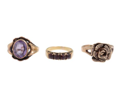 A group of three ringsa single stone amethyst ring, the mixed-cut amethyst set to bifurcated shoulders to a plain tapering sh