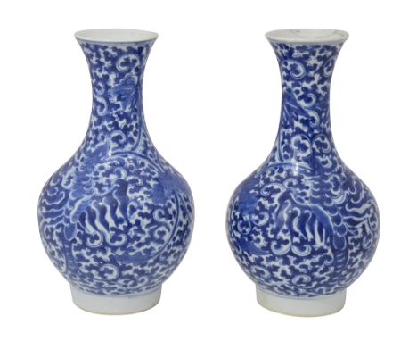 A pair of Chinese blue and white porcelain vaseslate 19th centuryof bottle form, decorated with entwined scrolling lotus foli