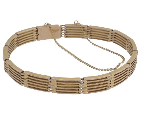 A 15ct gold six-bar gate bracelet with push clasp and safety chain, stamped '15ct' to tongue total approx weight 25.3gConditi