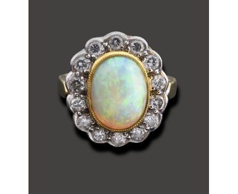 An opal and diamond-set cluster ringthe central oval cabochon opal measuring 10.6mm x 8.1mm x 4.7mm  collet-set above the sur