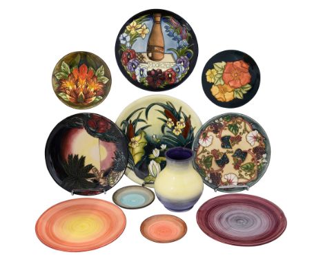 A collection of Modern Moorcroft pottery to include year plates and colour trial pieces comprising Centennial plate 1897-1997