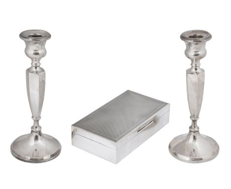 An Elizabeth II silver table cigarette box and a pair of candlesticksfirst London, 1964, S J Rose &amp; Sons, of plain rectan