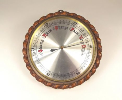 BAROMETER. A barometer in rope twist case. Diameter 28cm.