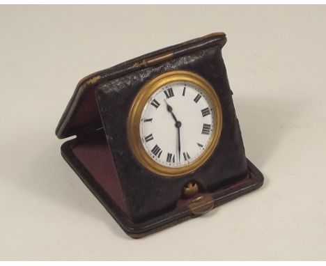 TRAVELLING CLOCK. A brass cased travelling clock in leather case.