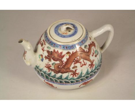 CHINESE TEAPOT.A Chinese porcelain dragon decorated teapot, the base with iron red, four character mark. Height 10cm.