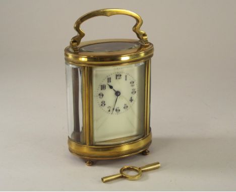 CARRIAGE CLOCK. A brass cased carriage clock with key. Height 16cm.