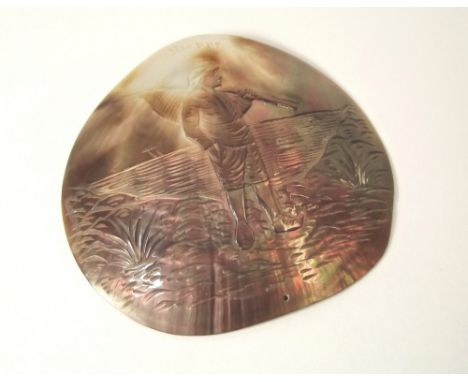 MOTHER OF PEARL. A souvenir mother of pearl shell, carved with a Dieppe fisherman. Width 9cm.