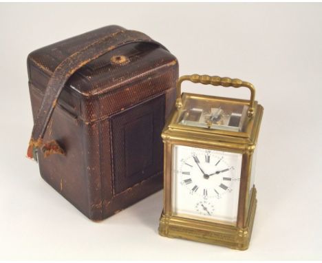 CARRIAGE CLOCK. A French brass cased carriage clock with bevelled glass sides & top. Repeater alarm movement, with keys & in 
