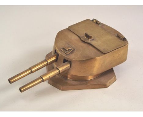 BATTLESHIP GUN TURRET INKWELL.A brass double inkwell in the form of a model of a German WWI battleship gun turret. The cover 