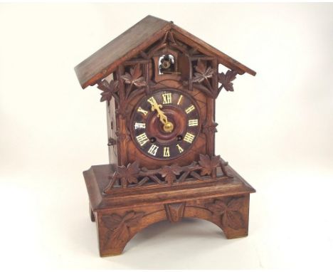 CUCKOO CLOCK. A 20th century cuckoo clock, striking on a gong. Height 34cm, width 26cm.