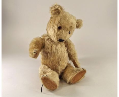 TEDDY BEAR. A Teddy bear with black stitched velvet pads & glass eyes. (Possibly a 1930's Chiltern Bear) Height 35cm.