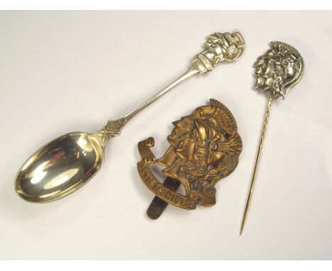 ARTIST'S RIFLES.An Artist's Rifles brass cap badge, a base metal stick pin & a silver hallmarked tea spoon, Mappin & Webb She