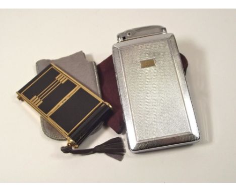 VANITY CASE ETC. A lady's black lacquered & gold tone musical vanity case & a chromium plated Mosda cigarette case/lighter.