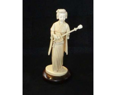 Japanese ivory Okimono, carved as a geisha playing a shamisen, Meiji period