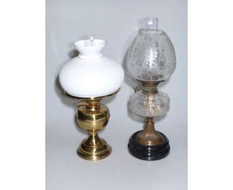 Brass oil lamp with opaque glass shade and copper and glass oil lamp with etched glass shade