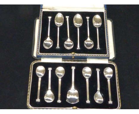 Set of six silver 'columnar' teaspoons with caddy shovel, cased; and another cased set of six silver 'seal' top teaspoons, ca