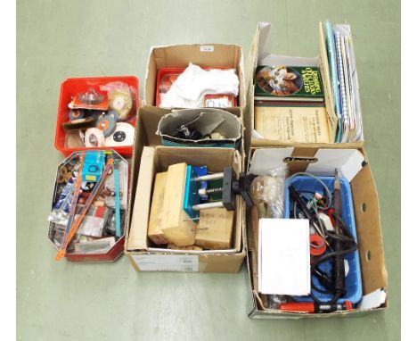 Assorted watch and clockmaker's tools and accessories including a soldering iron, various oils, glass press and dies, referen