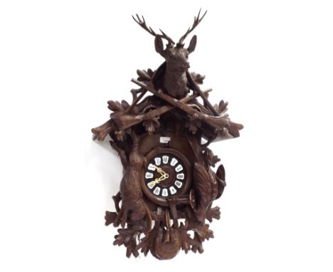 Large Black Forest three train cuckoo clock, the 6" wooden dial with Roman cartouche enamel numerals, within a chalet case ap