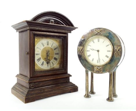 Silvered planished metal clock timepiece, the 3.25" circular dial within a planished drumhead surround upon hexagonal leg sup