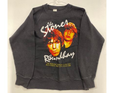 Three small women's Rolling Stones commemorative t-shirts with varying designs.