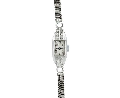 An Art Deco platinum cased, diamond set, lady's manual wind cocktail watch. The 8mm silvered dial with black Arabic numerals,