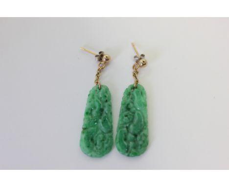 A pair of carved and pierced jade drop earrings