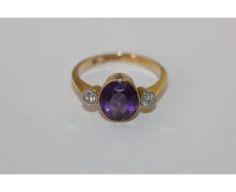 An amethyst and diamond millegrain set ring 