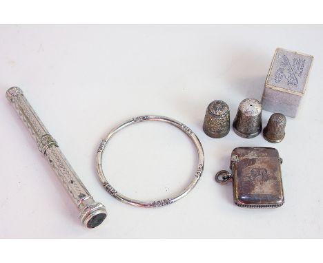 A Danish silver bangle by Laurits Berth, three silver thimbles, one with case, a silver vesta case and a silver plated propel