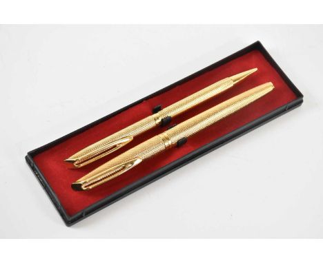 WATERMAN; a Plaque d'Or fountain pen and roller ball pen, with engine turned detailing, in associated box.
