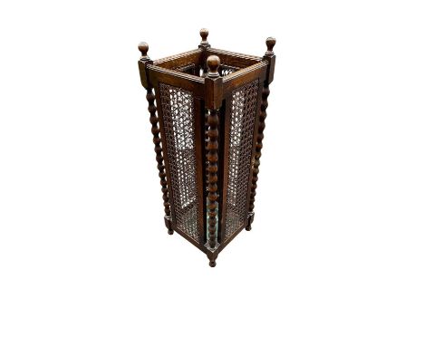 An early 20th century stick stand with cane work decoration with bobbin stretchers, height 77cm.