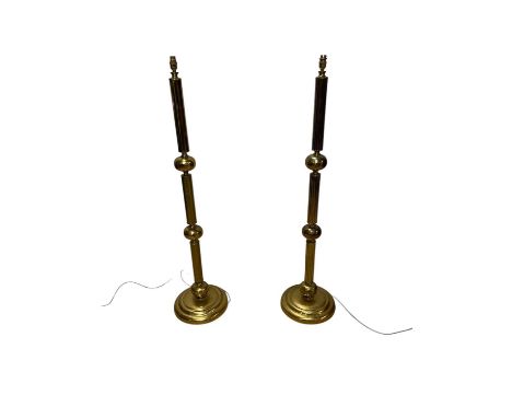 Two late Victorian brass ecclesiastical standard lamps, including an example with fluted decoration and on a three knop stem,