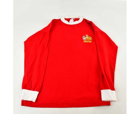 GEORGE BEST; a 1960s retro style football shirt, signed verso, size M.Condition Report: Light creasing and fading, no certifi