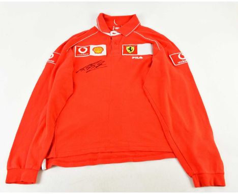 MICHAEL SCHUMACHER; a Ferrari Fila long sleeved polo top, signed to front, size L.Condition Report: Light creasing and fading