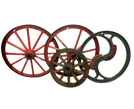Three vintage wooden cart wheels and a metal wheel/terminal (4).