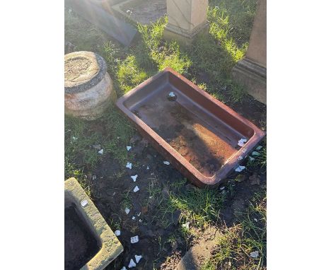 A vintage salt glazed sink with scrolling decoration to edge, 77 x 46cm.