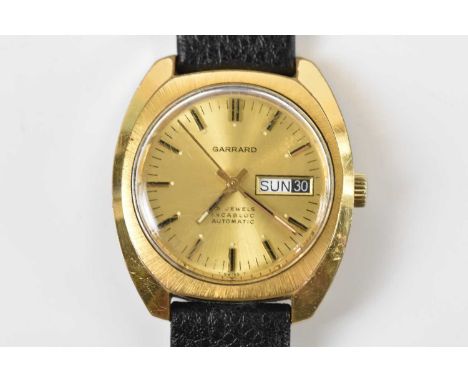 GARRARD; a gentleman’s gold plated wristwatch, the dial with batons for numerals and day and date aperture, later leather str