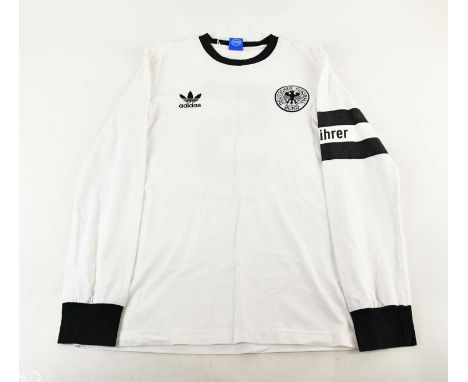 BECKENBAUER; a Germany retro style football shirt, signed verso.Condition Report: Light creasing and fading, no certificate o
