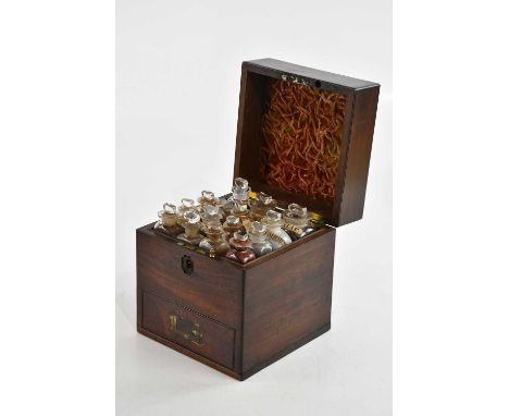 A 19th century mahogany apothecary cabinet, the hinged cover enclosing an arrangement of sixteen assorted bottles, with singl