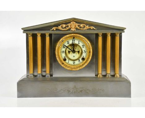 An early 20th century silvered metal architectural mantel clock, the dial set with Arabic numerals, signed by Ansonia Clock C