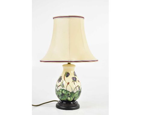 MOORCROFT; a decorative modern table lamp of baluster form with floral decoration, with shade, height including fitting 26cm.