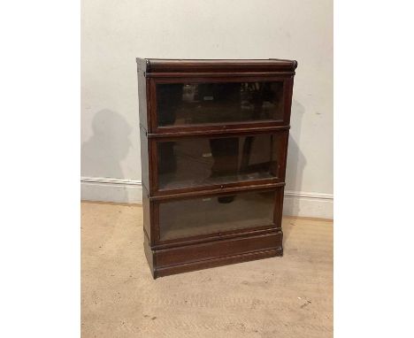 GLOBE WERNICKE; a metal bound oak three tier bookcase with up and over glazed doors, height 126cm, width 86cm.