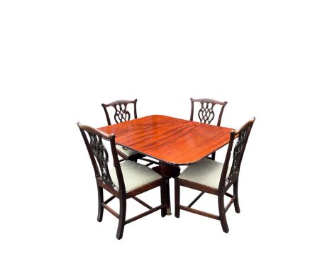 A George III mahogany extending single pedestal extending dining table with additional leaf, on sabre legs terminating on bra