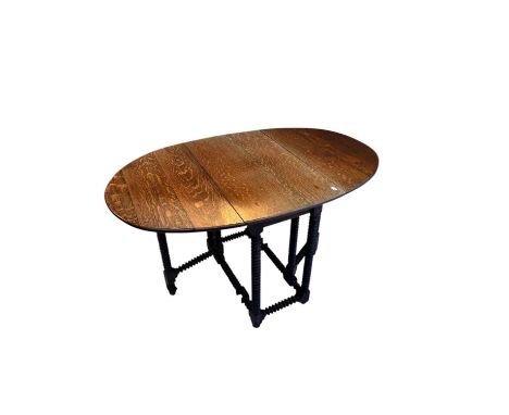 An 18th century and later oak drop-leaf gateleg dining table, the base section with bobbin supports, with later top, height 7