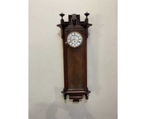 A late 19th century walnut and stained beech Vienna style wall clock, the enamel dial set with Roman numerals and subsidiary 
