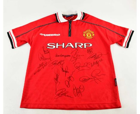 MANCHESTER UNITED; a Treble Winners retro style football shirt, signed to front by Scholes, G Neville, Solskjaer, Stam, Butt,